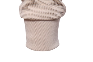 Detail of waffle knit fabric and ribbed cuff on beige stand collar jacket for men