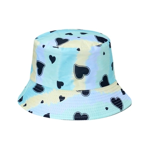 Women's tie-dye bucket hat with black heart patterns in blue and yellow pastel colors