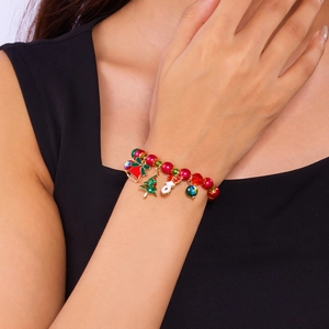 Detailed close-up of a Christmas themed beaded bracelet with colorful enamel charms