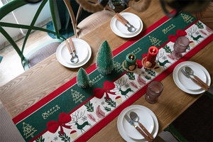 Christmas table runner with Merry Christmas text, reindeer patterns, and tassels on wood