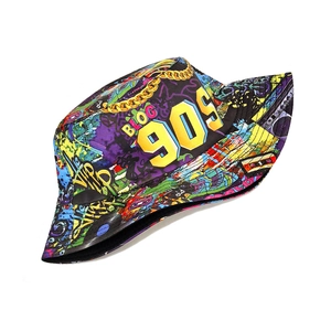 Detail of printed bucket hat featuring retro 90s cassette and graffiti art patterns