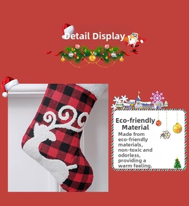 Detail of red and black buffalo plaid Christmas stocking with reindeer plush embroidery