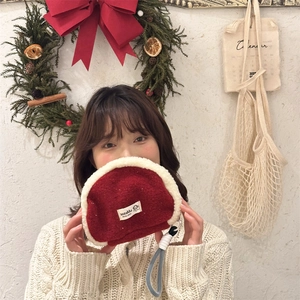 Detailaufnahme der Plüsch-Patchwork-Muscheltasche in Weinrot mit geflochtener Schlaufe
