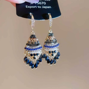 Detail view of Bohemian rhinestone fan earrings with black water drop bead tassels