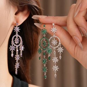 Detail showing long zircon flower tassel earrings in purple, green and white colors
