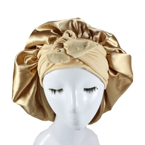 Detail of satin nightcap showing champagne gold fabric and khaki elastic headband