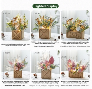 Mini lighted Christmas tree set in wooden pots showing sizes and warm LED details