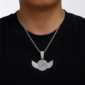 Close-up of hip hop silver iced out wing pendant with rope chain on model neck