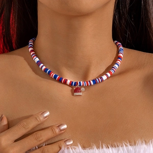 Close-up of beaded Christmas necklace featuring a rhinestone Santa hat pendant on model