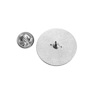 Detailed back view of a round silver metal badge featuring a needle and butterfly clasp