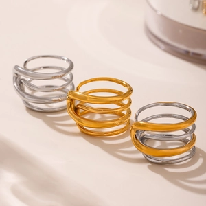 Minimalist multi-layer spiral ring in gold, silver, and two-tone finishes on beige background