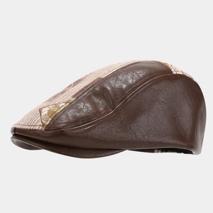 Detail of retro flat cap featuring vintage PU leather stitching and patterned fabric