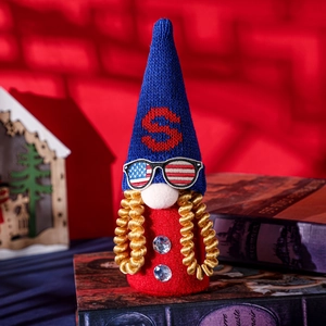 Macro view of patriotic gnome with USA sunglasses and golden beard on vintage books