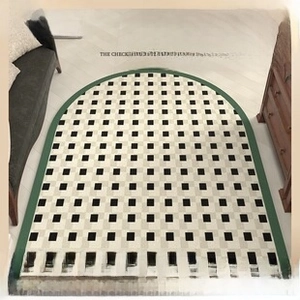 Macro detail of French vintage checkered leather floor mat with non-slip green border edge