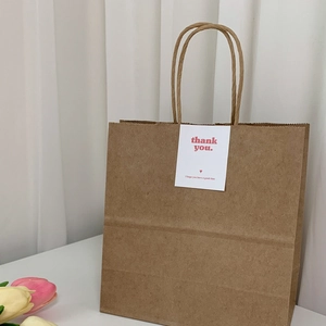 Minimalist brown kraft paper gift bag with printed Thank You card and paper handles