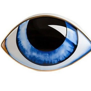 Minimalist evil eye ceramic ornament with blue iris and glossy gold rim on white background