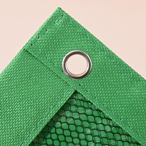 Green shade net detail with reinforced metal eyelet and durable woven edges