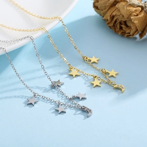 Detail of star and moon necklaces in gold and silver finish with crystal accents
