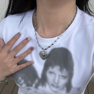 Vintage silver heart embossed pendant necklace with unique link chain on model