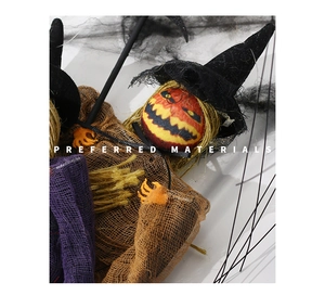 Detailed close-up of Halloween pumpkin witch ornament with mesh gauze and burlap textures