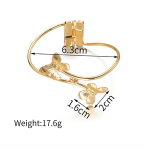 Detailed view of gold butterfly bracelet with 6.3cm inner diameter and spring clasp