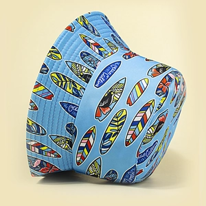 Light blue bucket hat with colorful surfboard prints and The Ocean Calling embroidery