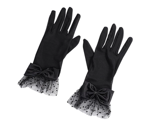 Detail of black bridal gloves with satin bow and polka dot mesh ruffle trim decorations