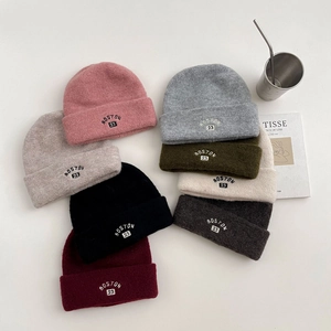 Flat lay of wool knit beanies in various colors with Boston 23 embroidery detail
