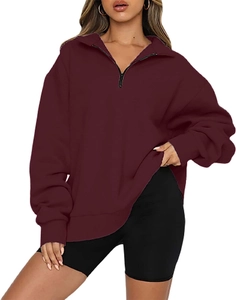 Detail of burgundy quarter-zip sweatshirt showing ribbed cuffs and drop shoulder design