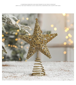 Close-up of golden hollow Christmas tree topper star with glitter finish and spiral base