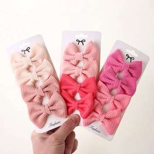 12-piece baby girl fabric bow hair clip set in various pink and peach shades