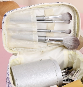 Detail view of large floral makeup bag with elastic brush slots and spacious interior storage