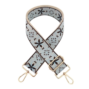 Detail of 5cm wide embroidered jacquard bag strap in light blue with gold metal hooks