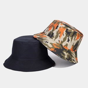 Detail view of cotton bucket hats in navy blue and orange-green camouflage pattern