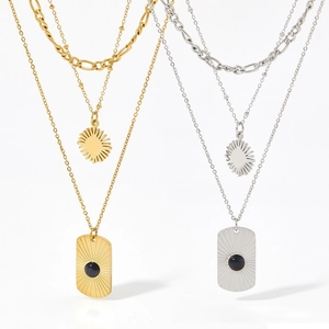 Double layered gold and silver Figaro necklaces with black onyx square sunburst pendant