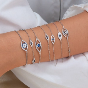 Stack of 925 sterling silver evil eye bracelets with blue and white zircon stones