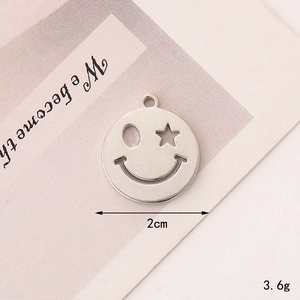Silver smiley face charm pendant with star and oval hollow eyes, 2cm diameter
