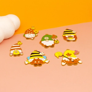 Macro detail of six gnome and honey bee enamel pendants for DIY jewelry making
