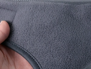 Macro shot of thick dark gray polar fleece fabric with durable reinforced stitching