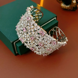 Close-up of luxury silver open cuff bracelet with pavé white and pink zircons