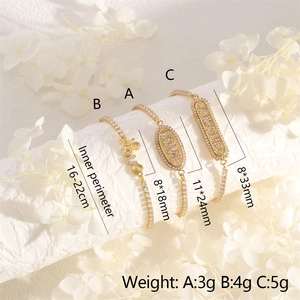 Adjustable gold letter bracelets with cubic zirconia LOVE and AMOUR charms on a display stand