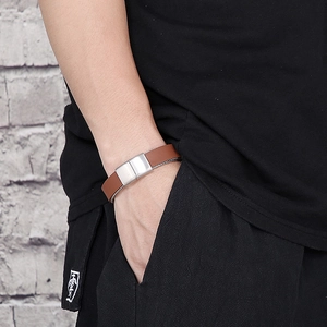 Close-up of brown braided leather bracelet with a silver stainless steel magnetic clasp