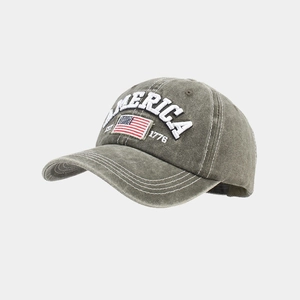 Detail of embroidered America text and US flag on washed cotton baseball cap