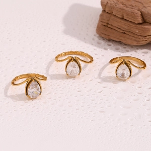 Detailed macro view of three 18K gold plated teardrop rings with white zircon stones
