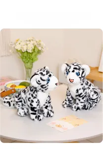 Detailed view of two plush snow leopard cubs with blue eyes on a decorated white table