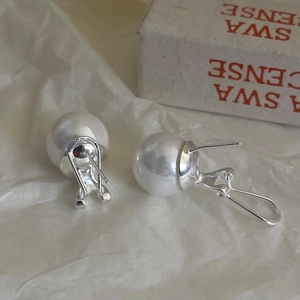 Elegant 925 sterling silver hoop earrings with large round white pearls in a warm setting
