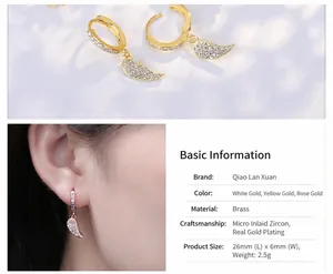Close-up of heart-shaped wing earrings with micro-inlaid cubic zirconia and gold plating