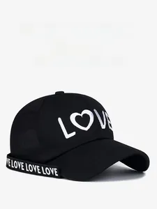 Detail of black baseball cap with white LOVE heart embroidery and lettered strap