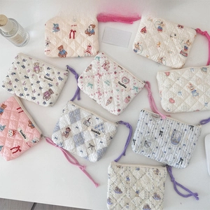Flat lay of floral quilted cosmetic pouches in various patterns and pastel colors