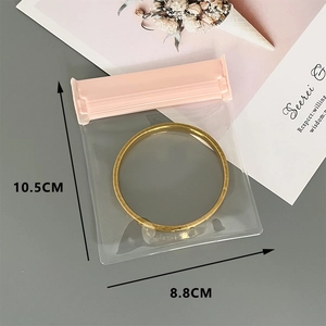 Macro view of a gold bracelet inside a pink frosted EVA anti-oxidation jewelry bag